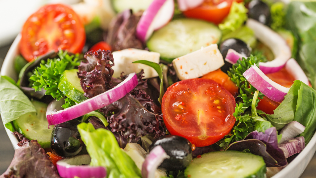 Fresh salad with vegetables and healthy whole foods for breaking a 3-day juice cleanse safely