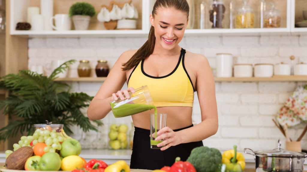 Woman preparing fresh green juice during a juice fasting program